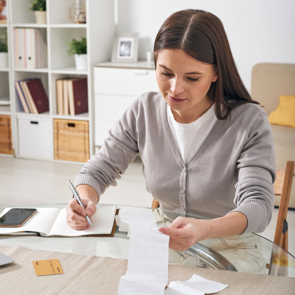 An image of a woman tracking her expenses.