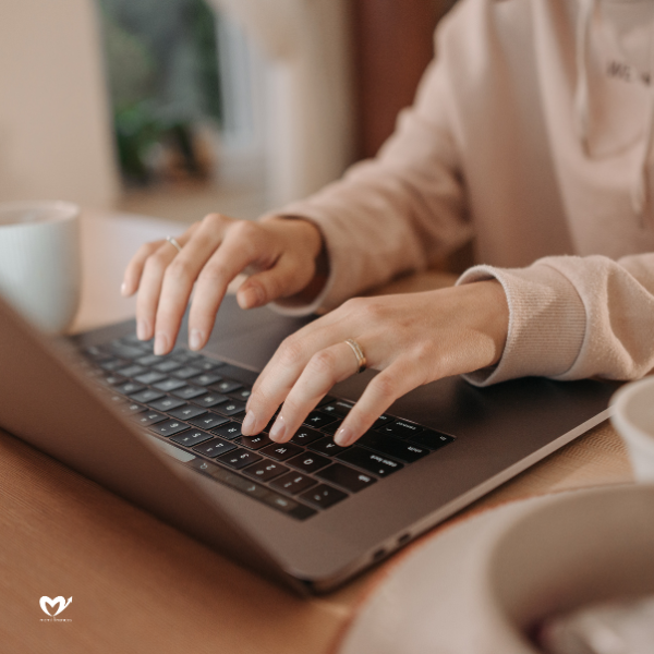 A Person Typing on a Laptop