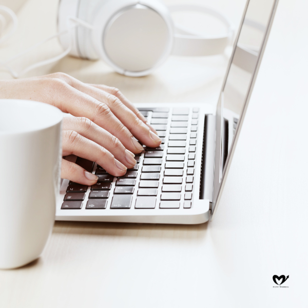 Woman working on laptop on a desk