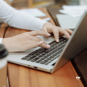 woman hands typing on a laptop