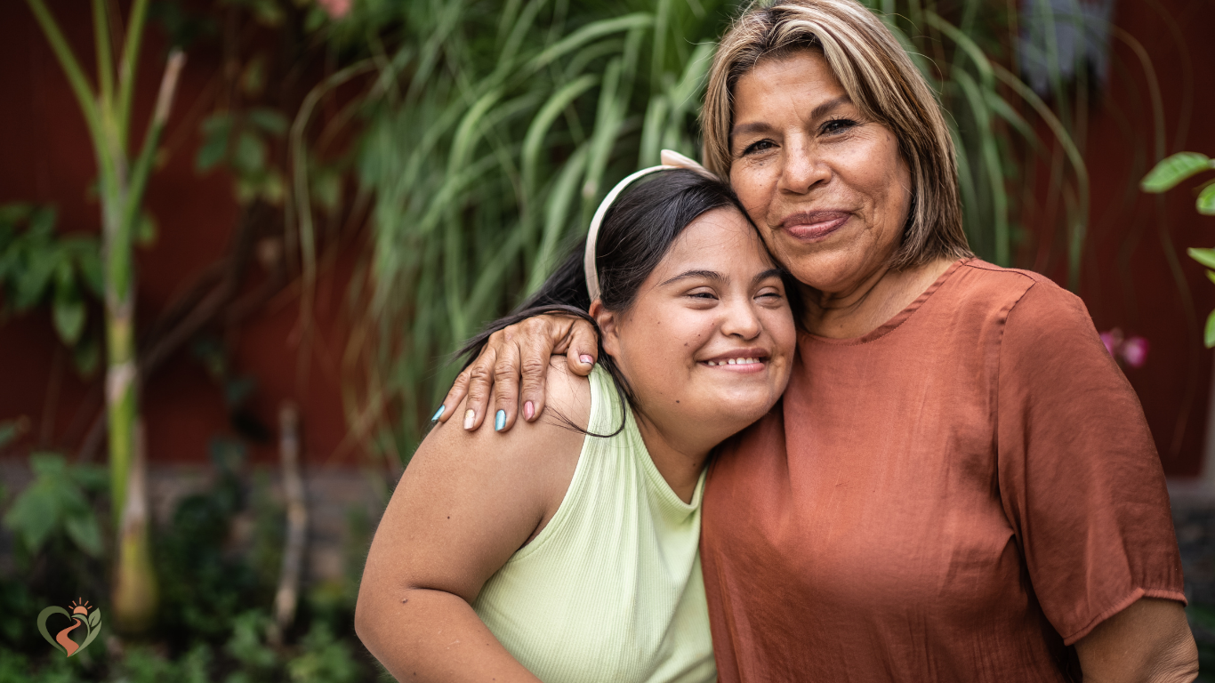 Older woman embracing a younger woman outdoors, representing moms of children with disabilities and the realities of family caregiving.